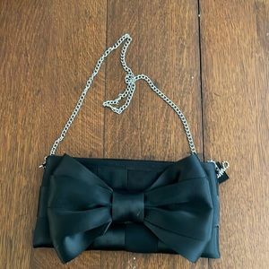 Harvey’s black clutch with bow